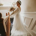 A bride looks up the stairs at Wressle Grange
